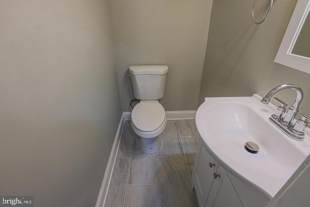 bathroom featuring hardwood / wood-style floors, vanity, and toilet