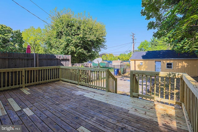 wooden terrace featuring an outbuilding