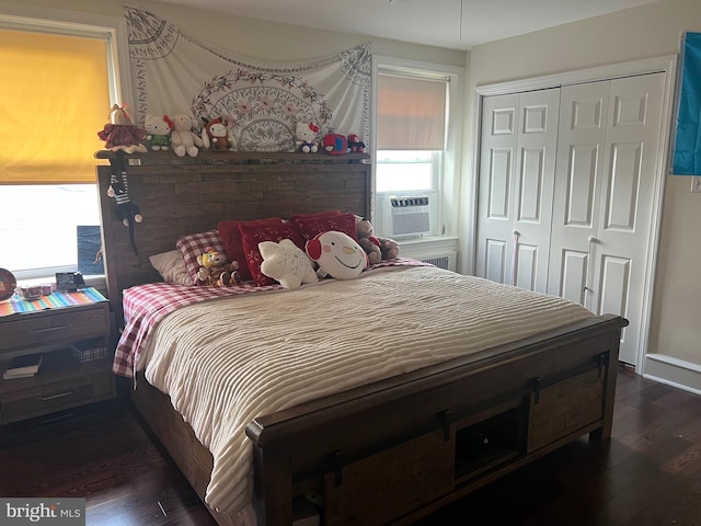 bedroom featuring dark hardwood / wood-style flooring, a closet, and cooling unit