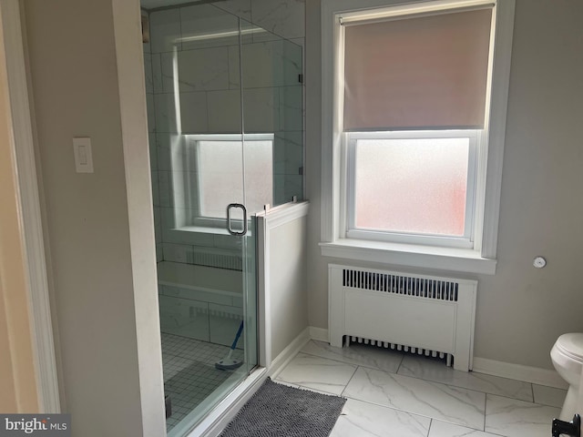 bathroom with radiator heating unit, toilet, and an enclosed shower