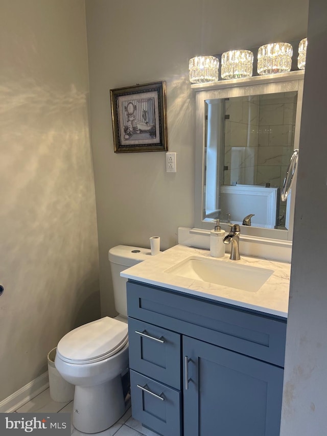 bathroom featuring tile patterned floors, vanity, and toilet