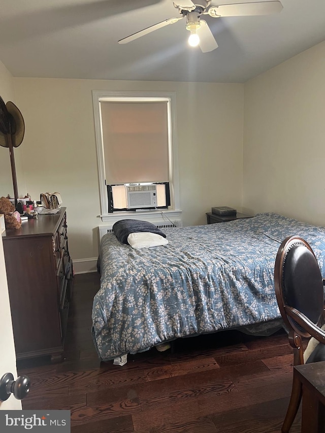 bedroom featuring ceiling fan, dark hardwood / wood-style floors, and cooling unit