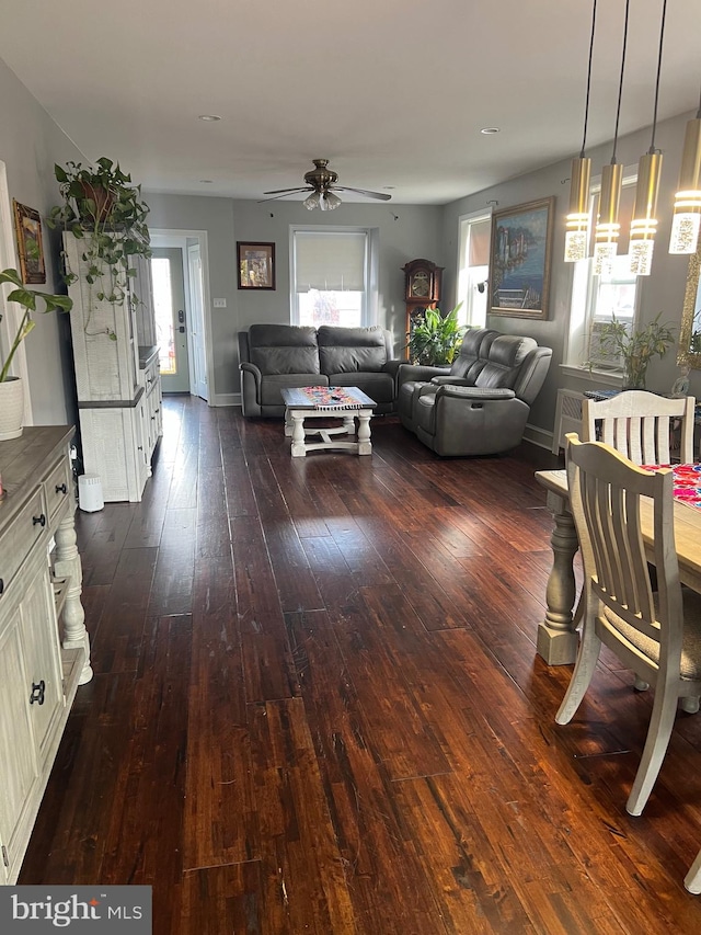 unfurnished dining area featuring ceiling fan and dark hardwood / wood-style flooring