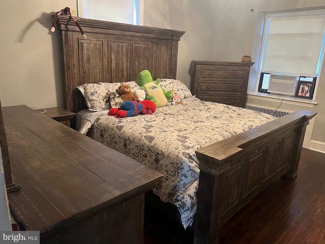 bedroom featuring dark hardwood / wood-style flooring and cooling unit