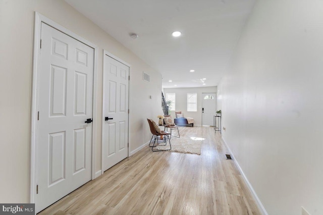 hall with light hardwood / wood-style floors