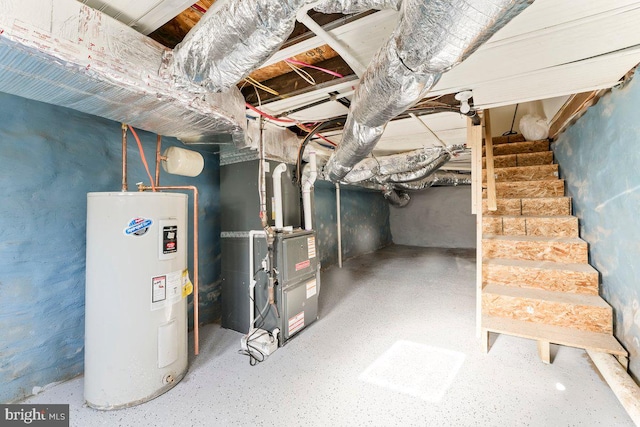 basement featuring electric water heater and heating unit