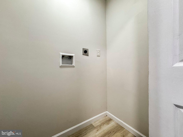 washroom with light hardwood / wood-style flooring and electric dryer hookup