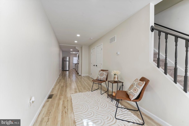 corridor with light hardwood / wood-style flooring