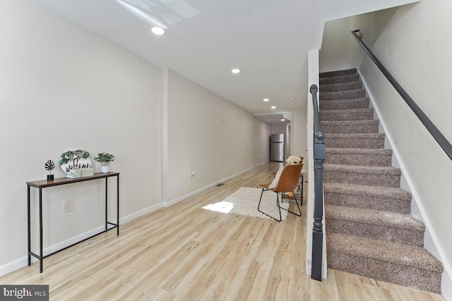 stairway with hardwood / wood-style flooring