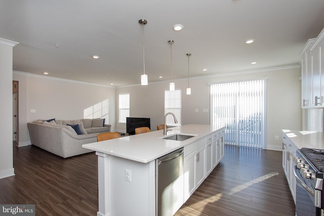 kitchen featuring white cabinetry, stainless steel appliances, sink, and a center island with sink