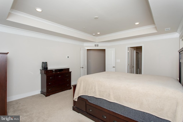 bedroom featuring crown molding, light carpet, and a tray ceiling