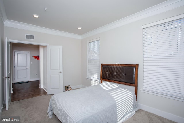 carpeted bedroom with ornamental molding