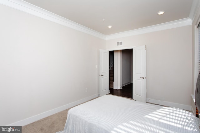 carpeted bedroom featuring ornamental molding