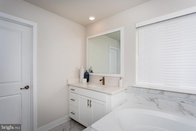 bathroom featuring vanity and tiled bath