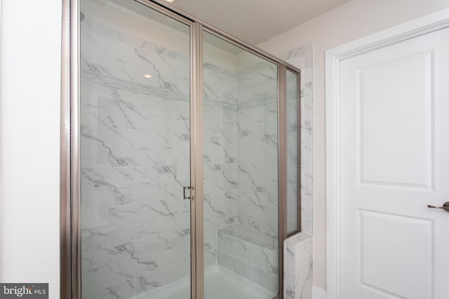 bathroom with a shower with shower door