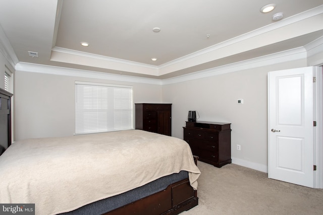 bedroom featuring crown molding, light colored carpet, and a tray ceiling