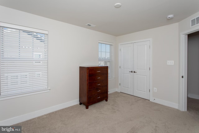 carpeted bedroom featuring a closet