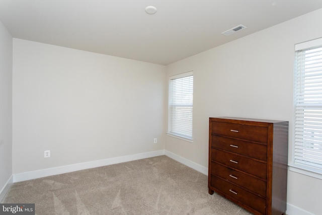 empty room featuring light carpet