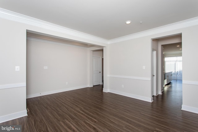 unfurnished room featuring dark wood-type flooring and ornamental molding