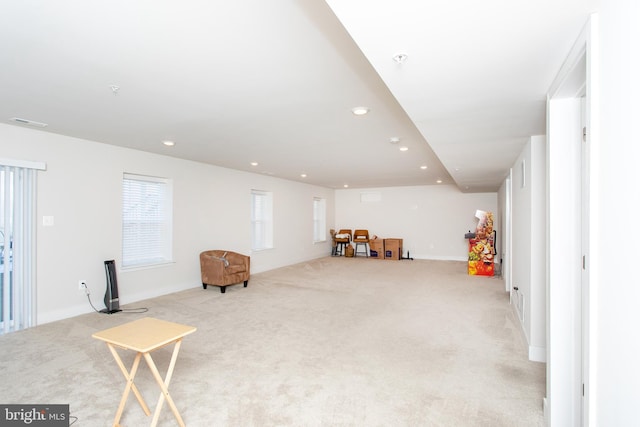 recreation room with light colored carpet