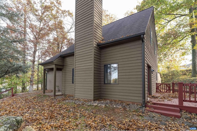 view of side of property featuring a wooden deck