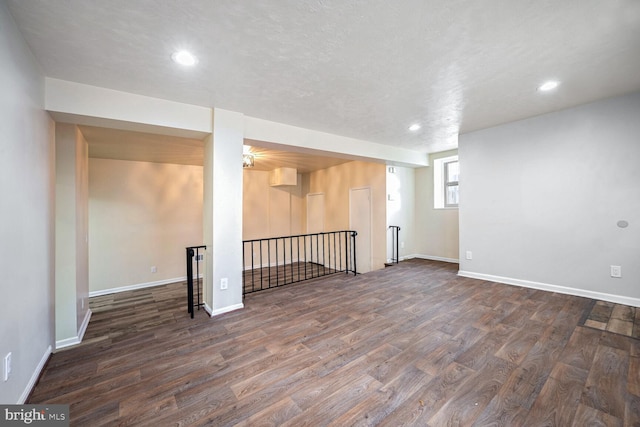 basement with dark hardwood / wood-style flooring