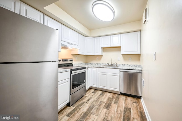 kitchen featuring white cabinetry, sink, appliances with stainless steel finishes, and light hardwood / wood-style flooring