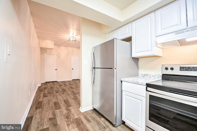 kitchen with white cabinets, stainless steel appliances, and light hardwood / wood-style floors