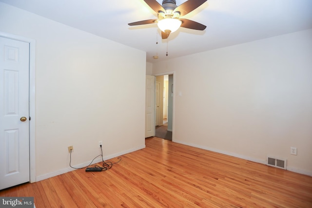 spare room featuring light wood-type flooring and ceiling fan