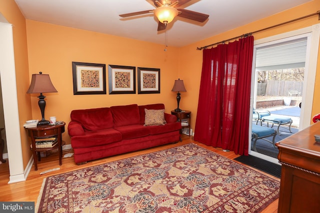 living room featuring ceiling fan and light hardwood / wood-style flooring