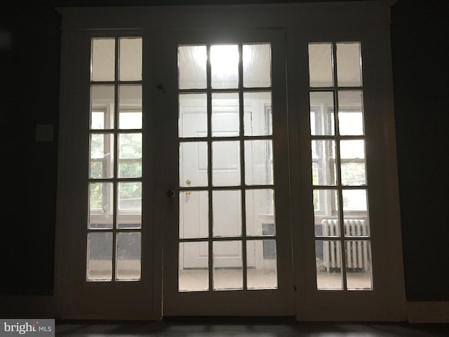 entryway featuring radiator heating unit and french doors