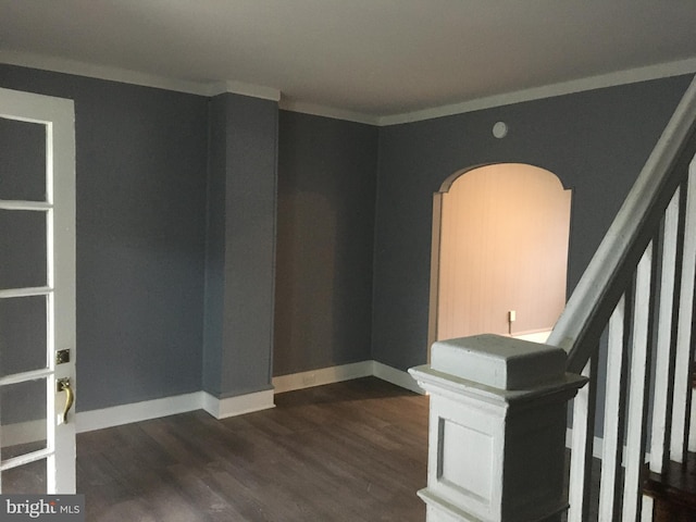 empty room featuring dark hardwood / wood-style flooring and ornamental molding