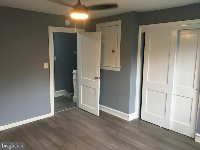 unfurnished bedroom featuring dark hardwood / wood-style floors and ceiling fan