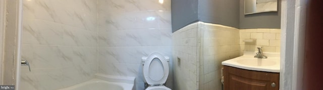 full bathroom featuring shower with separate bathtub, vanity, tile walls, and toilet