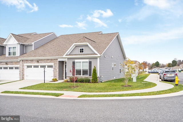 view of front of home with a front lawn and a garage