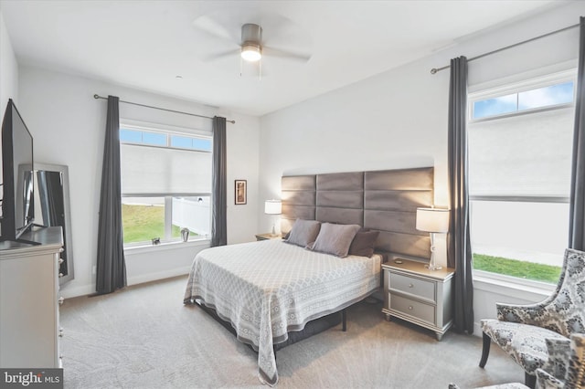 bedroom with ceiling fan and light carpet