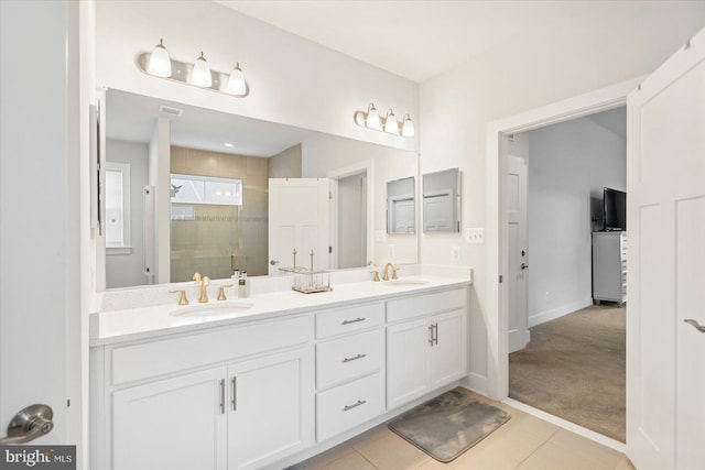 bathroom with tile patterned floors, vanity, and walk in shower