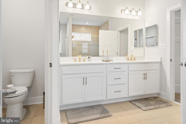 bathroom with tile patterned flooring, vanity, toilet, and a shower with door