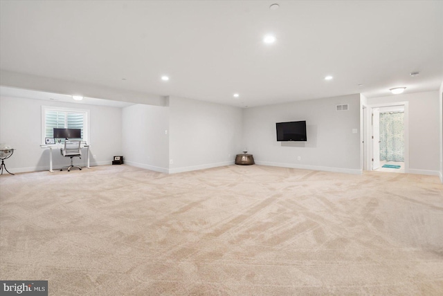 unfurnished living room featuring light colored carpet