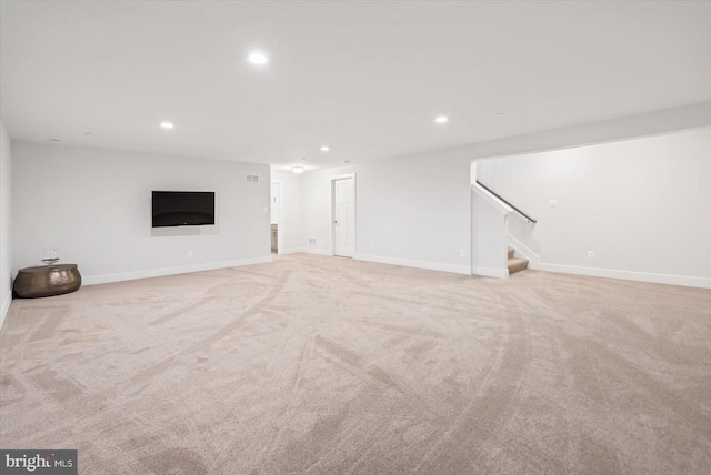 basement featuring light carpet