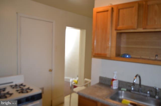 kitchen with white range oven and sink