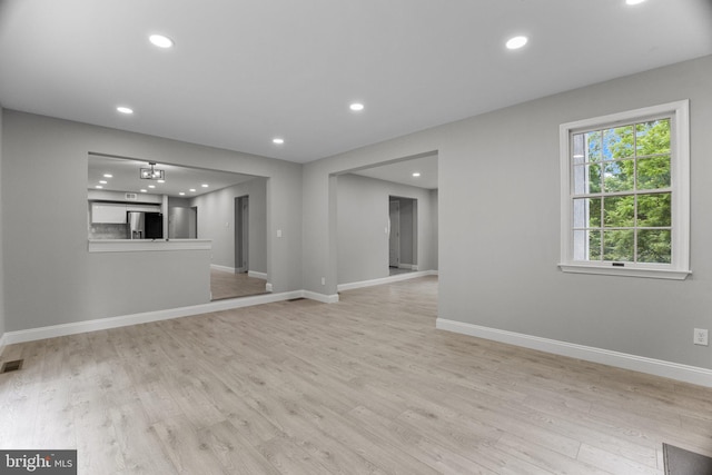 unfurnished living room featuring light wood-type flooring