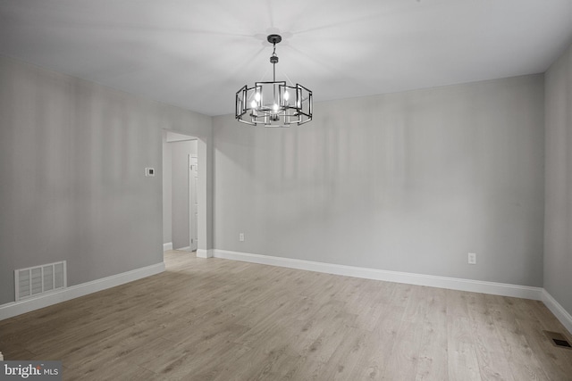 interior space with a notable chandelier and light wood-type flooring