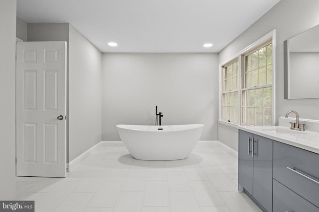 bathroom featuring vanity and a tub