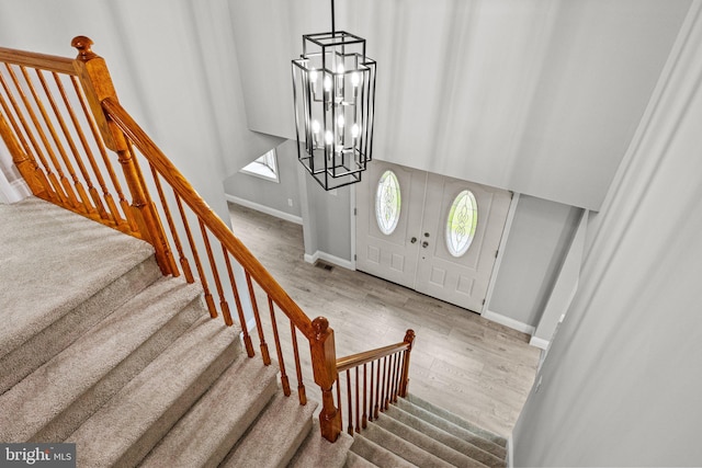 entrance foyer with an inviting chandelier and wood-type flooring