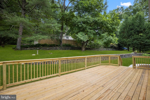 wooden terrace featuring a yard