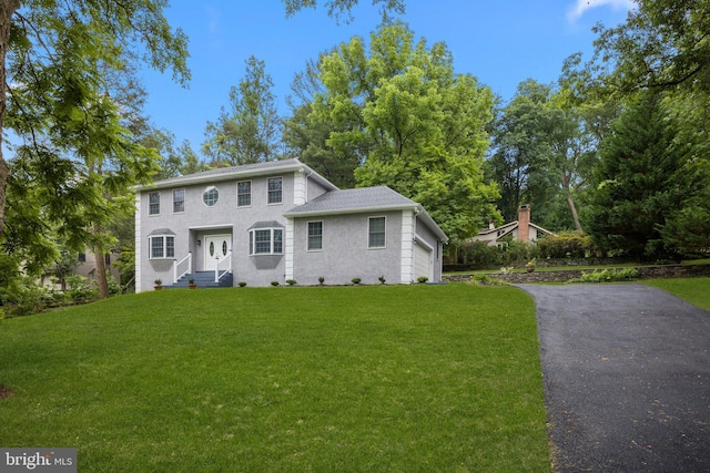 view of front of home featuring a garage and a front lawn