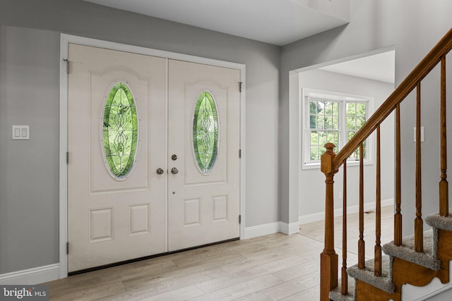 foyer featuring french doors and light hardwood / wood-style floors