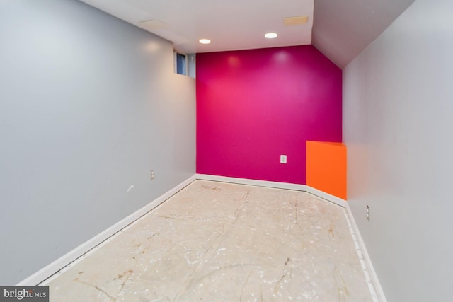 empty room featuring lofted ceiling