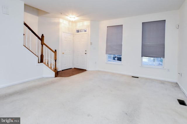 view of carpeted foyer